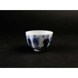 A Chinese blue & white wine cup, Qing, painted with eight immortals above a band of waves,