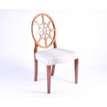 A Georgian style wheel back dining chair with satinwood veneer, the overstuffed seat on plain
