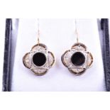 A pair of Art Deco diamond and onyx earrings, of quatrefoil design, each inset with a round onyx