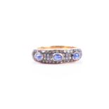 A silver gilt, diamond, and sapphire ring, set with three cabochon sapphires, the mount pave set