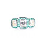 A diamond and emerald ring, set with an emerald-cut diamond flanked with two mixed square-cut