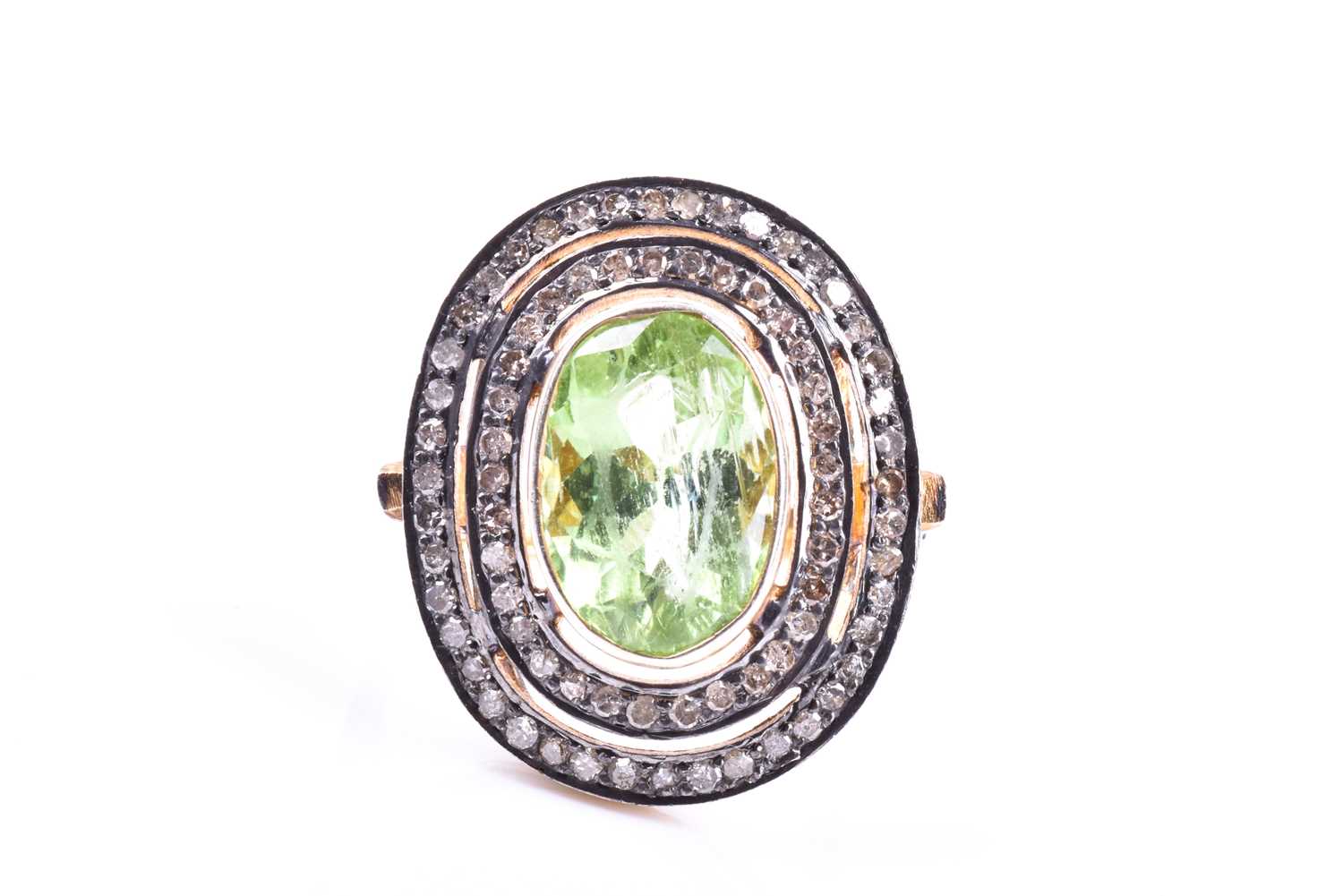 A silver gilt, peridot, and diamond cocktail ring, the silver gilt mount set with a mixed oval-cut