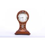 An Art Nouveau mahogany balloon-cased mantel clock, with inlaid brass and mother-of-pearl marquetry,