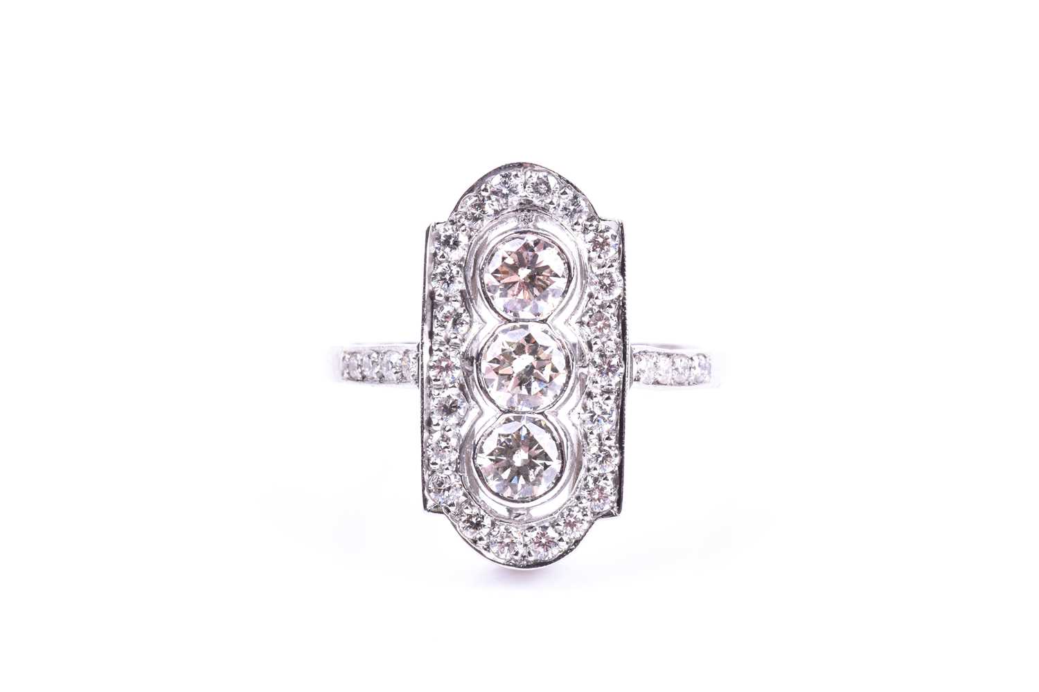 A platinum and diamond ring, in the Art Deco style, the lozenge-shaped plaque ring inset with