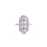 A platinum and diamond ring, in the Art Deco style, the lozenge-shaped plaque ring inset with