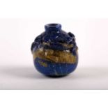 A Chinese carved lapis lazuli snuff bottle, 19th/20th century, carved as a miniature vase, a chilong