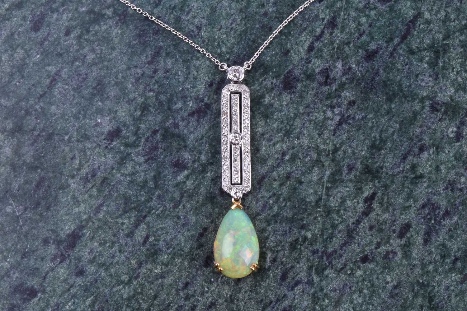 A diamond and opal drop pendant necklace in the Art Deco style, set with a pear-shaped cabochon opal