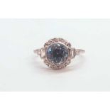 A diamond and blue zircon ring, set with a natural zircon of approximately 2.54 carats, within a