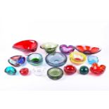 A collection of mid-20th century art glass, to include bowls, ashtrays and paperweights, the largest