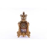 A 19th century French ormolu mantel clock, surmounted by a vase with bellflower swags and lion