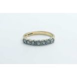 A 9ct yellow gold and diamond half eternity ring, set with seven round-cut diamonds of approximately