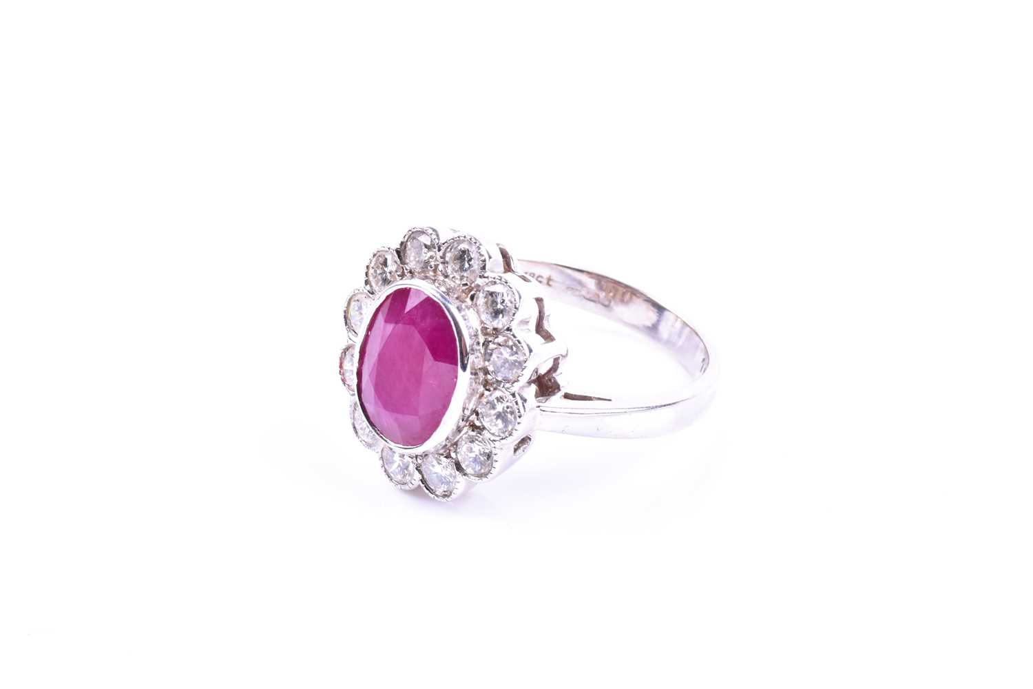 An 18ct white gold, diamond, and ruby cluster ring, set with a mixed oval-cut ruby of - Image 2 of 4