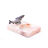 A marble trinket dish surmounted with a small cold painted bronze leaping Salmon, early 20th