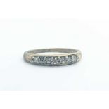 A 9ct yellow gold and diamond ring, set with a row of seven small round-cut diamonds, size N, 1.8