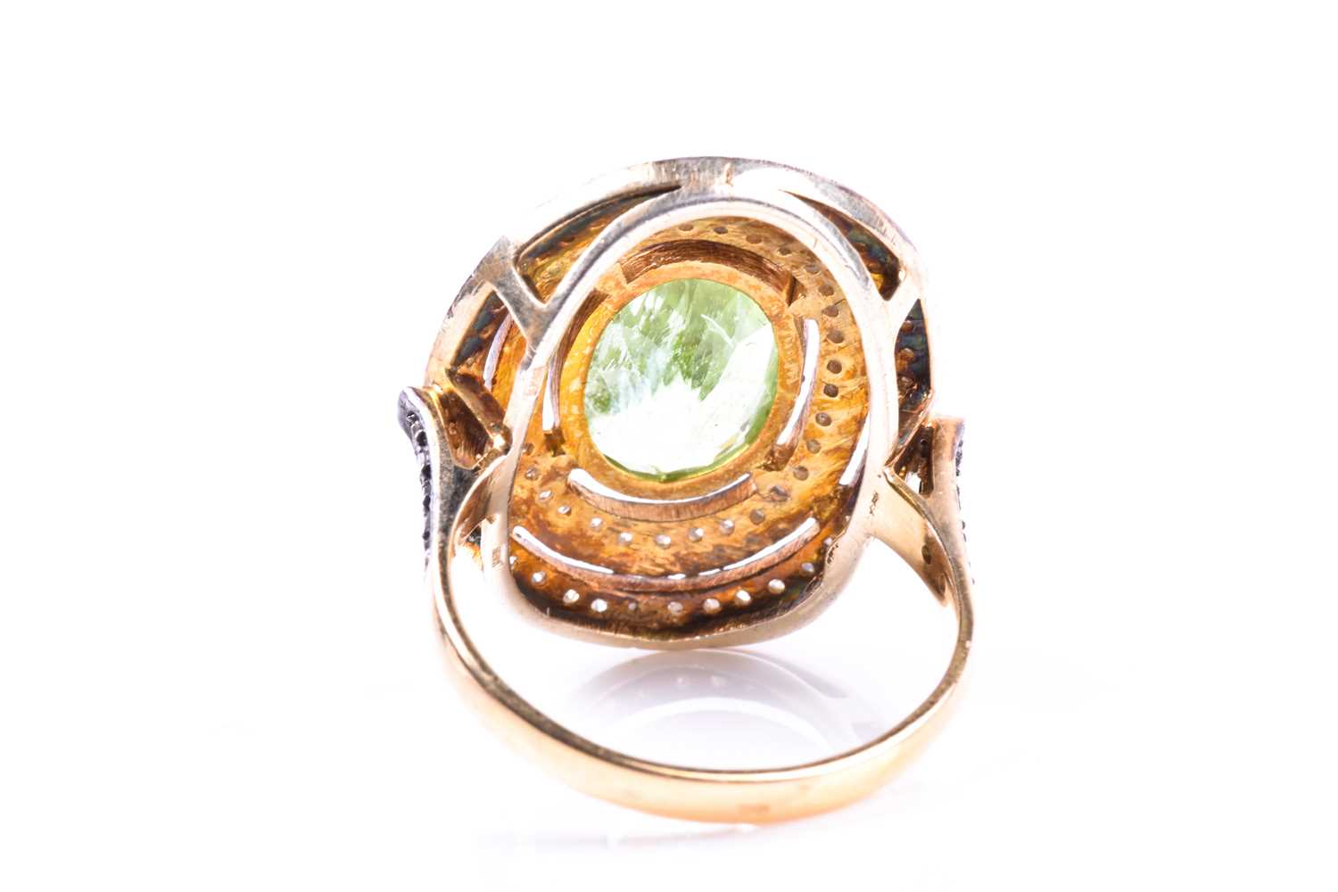 A silver gilt, peridot, and diamond cocktail ring, the silver gilt mount set with a mixed oval-cut - Image 2 of 4