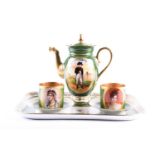 A Limoges cabaret set, 20th century, the teapot painted with a panel of Napoleon, the cups painted