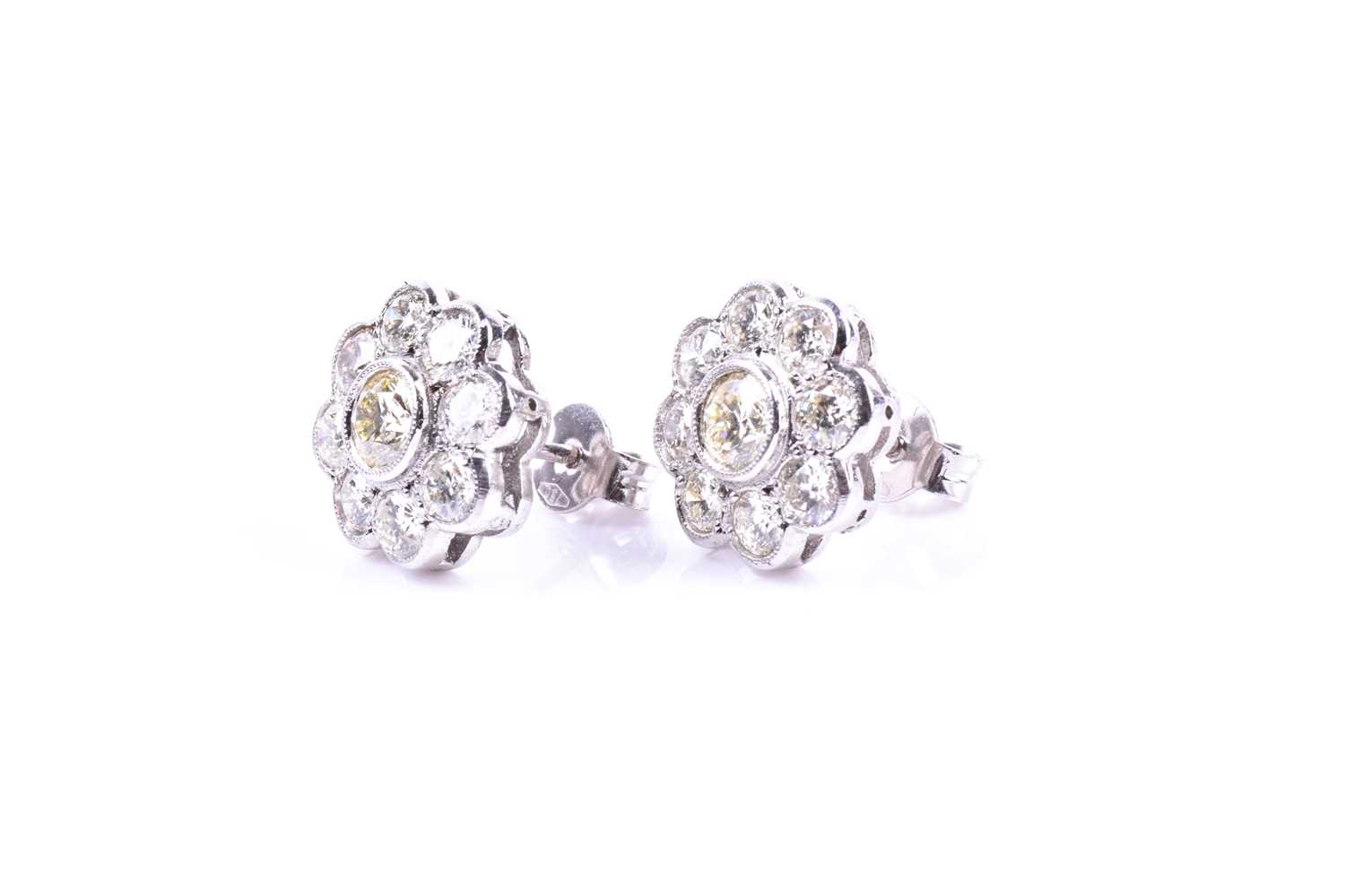 A pair of diamond floral cluster earrings, set with round brilliant-cut diamonds of approximately - Image 2 of 3