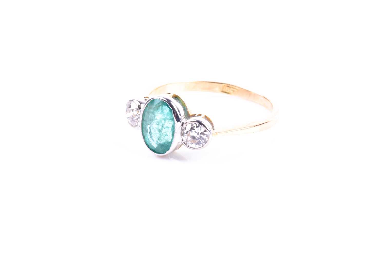 An 18ct yellow gold, diamond, and emerald ring, collet-set with a mixed oval-cut emerald of - Image 4 of 5