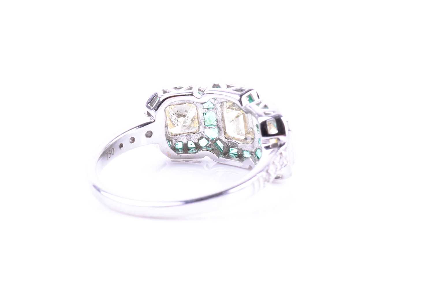 A diamond and emerald ring, set with an emerald-cut diamond flanked with two mixed square-cut - Image 4 of 5