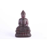 A Chinese bronze buddha, seated in Dyhana mudra, traces of red pigment and gilt throughout, on