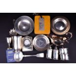 A collection of mixed silver and white metal items to include pin dishes, cruets, sauce ladle, easel
