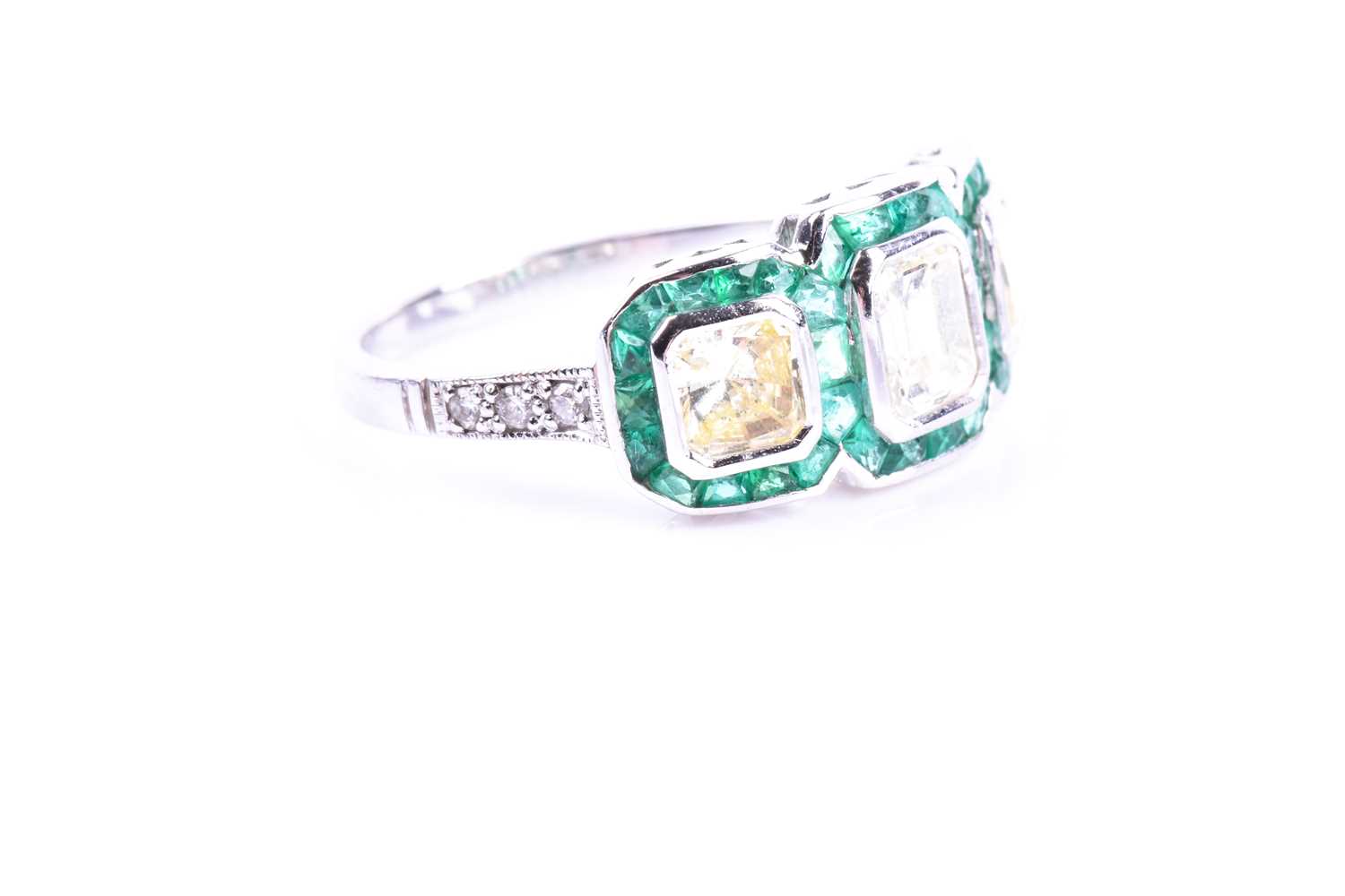 A diamond and emerald ring, set with an emerald-cut diamond flanked with two mixed square-cut - Image 5 of 5