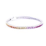An 18ct white gold and rainbow sapphire bracelet, set with multi-coloured sapphires ranging from