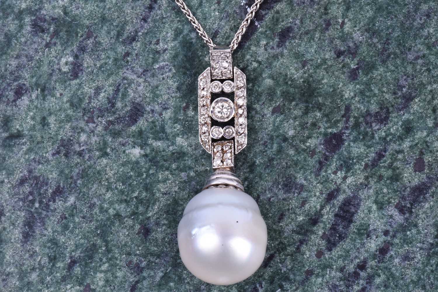 A diamond and pearl pendant, the rectangular plaque mount inset with round-cut diamonds, and