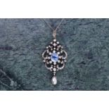An impressive diamond, sapphire, and pearl pendant, the openwork mount centred with a cushion-cut