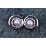 A pair of 14ct white gold, diamond, and pearl earrings of circular form, designed as concentric