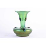 An Art Nouveau design green glass vase, with applied trails and lustre finish, of compressed body