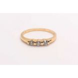 A 14ct yellow gold and diamond ring, bar-set with three small round brilliant-cut diamonds of