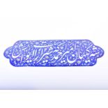 An enamel Persian sign, with calligraphic script against a blue ground with floral sprays, signed