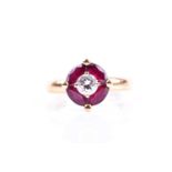 A Continental yellow gold, diamond, and ruby cluster ring, set with a round brilliant-cut diamond of