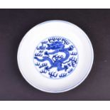 A Chinese blue and white dragon dish, the interior painted with an imperial dragon and sacred