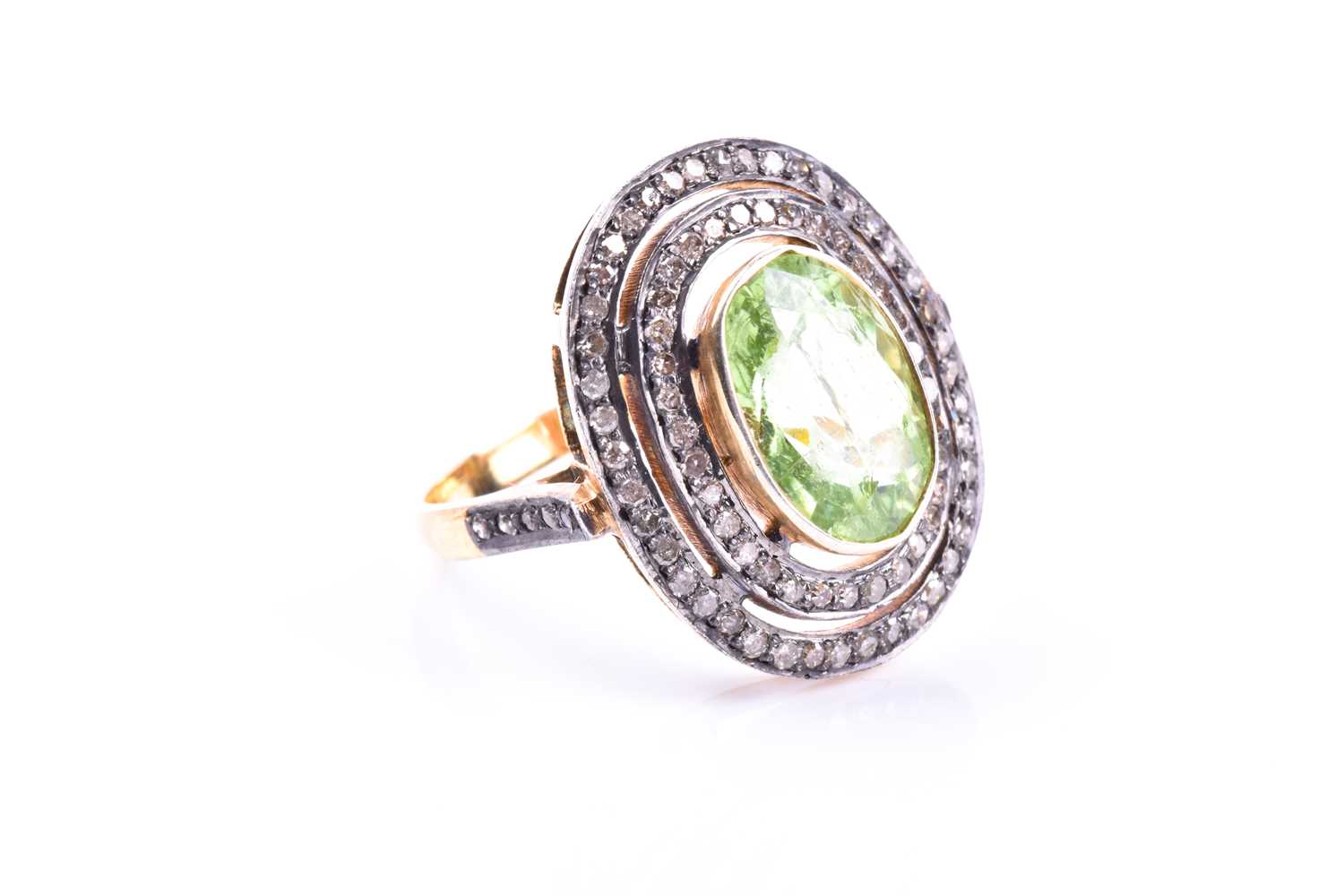 A silver gilt, peridot, and diamond cocktail ring, the silver gilt mount set with a mixed oval-cut - Image 3 of 4