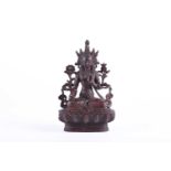 A Sino Tibetan bronze figure of Tara, traces of red pigment throughout, on lotus petal throne