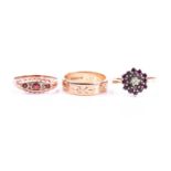 A 9ct gold engraved wedding band; a three stone half hoop garnet ring in 9ct rose gold mount, and