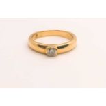 An 18ct yellow gold and diamond ring, collet-set with a round-cut diamond of approximately 0.20