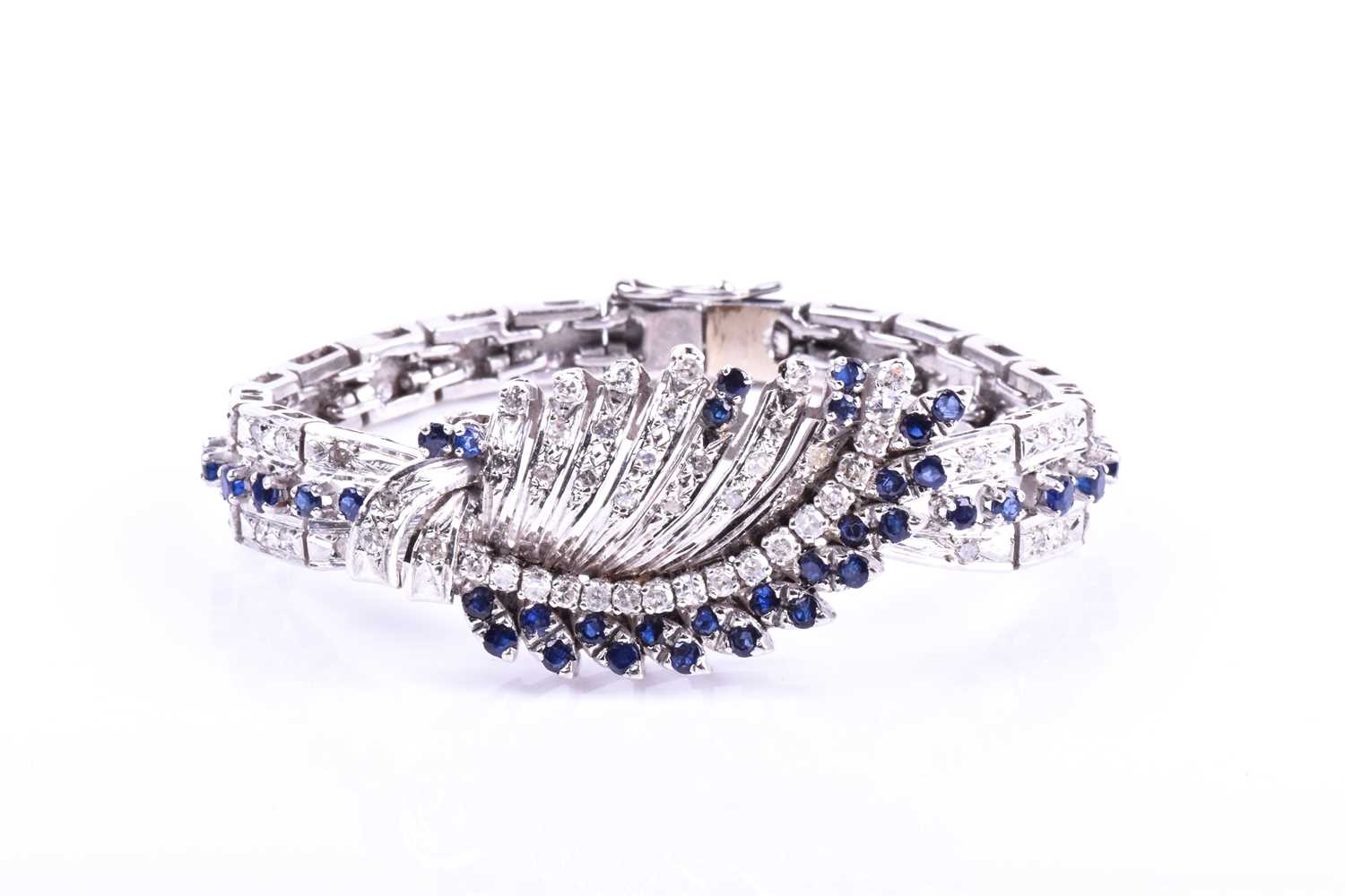 A white metal, diamond, and sapphire bracelet, the swept central segment set with round brilliant-