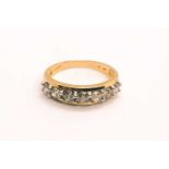 An 18ct yellow gold and diamond ring, the tapered mount set with a row of seven round brilliant-