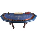 An original Ritz (London) croupier’s baccarat card table, with gaming chips and related items,