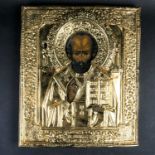 A 19th century painted Russian icon on wood, with later overlaid gilt metal plaque, relief