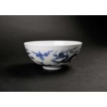 A Chinese blue 7 white dragon bowl, Republic period, painted with two Imperial dragons amongst