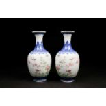 A pair of Chinese Famille rose vases, the neck painted with a band of ruyi heads above a shoulder of