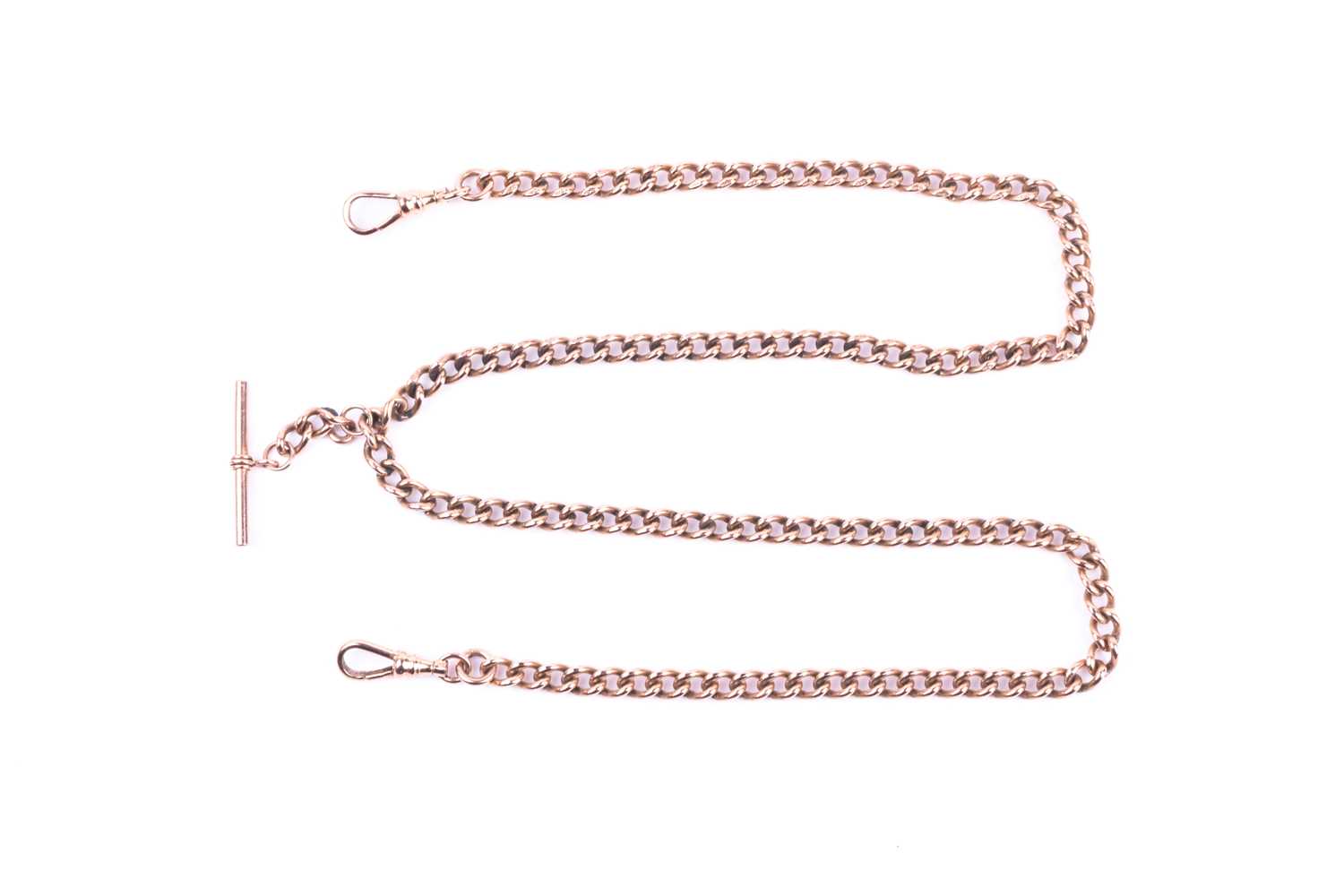 A 9ct rose gold watch chain, the graduated curb pattern double Albert with sprung clasps and T