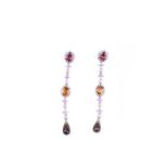 A pair of diamond, sapphire, and tourmaline drop earrings, set with a mixed oval-cut pink tourmaline