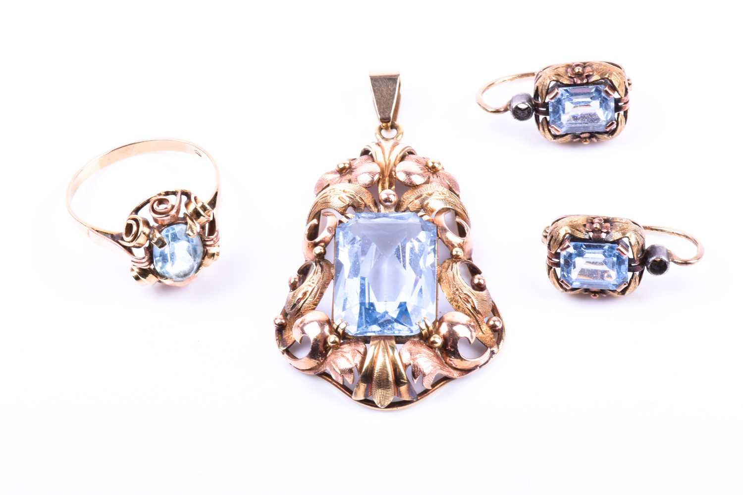 A blue topaz dress suite, the pendant with a rectangular cut-cornered topaz in two colour pierced