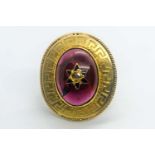 A yellow gold and garnet ring, centred with an oval cabochon garnet, inset with rose-cut diamond and