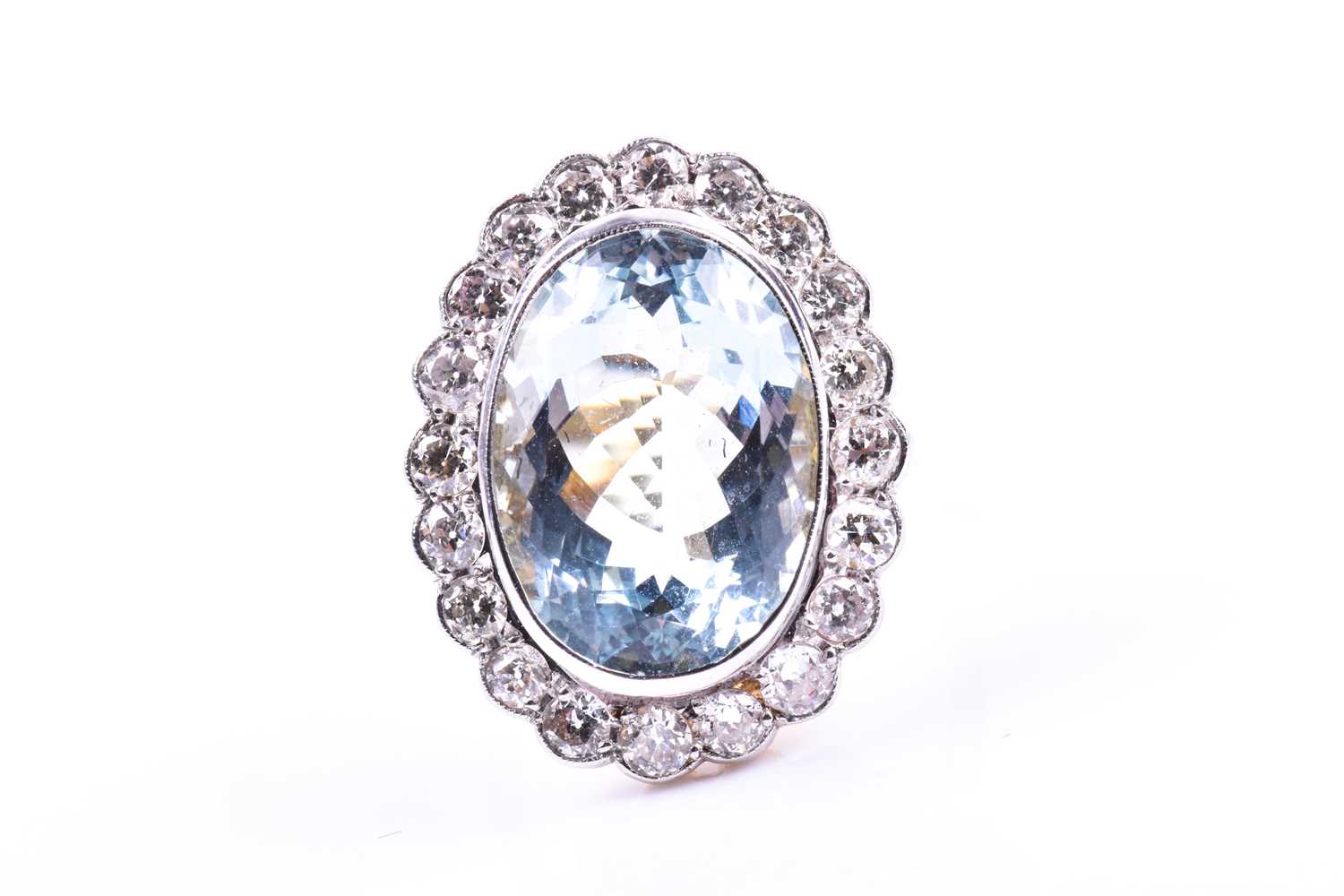 An 18ct yellow gold, diamond, and aquamarine cocktail ring, set with a mixed oval-cut aquamarine